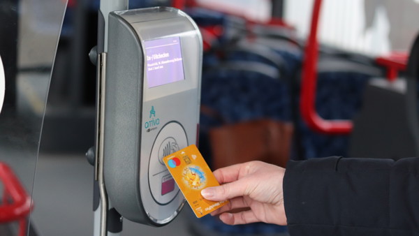 Iemand checkt in een bus van Arriva met de betaalpas in. Iemand checkt in een bus van Arriva met de betaalpas in.