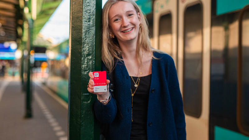 Meisje laat OVpay pas, op achtergrond Arriva trein Meisje laat OVpay pas, op achtergrond Arriva trein