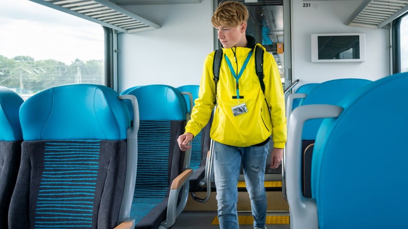 Jongen in gele jas loopt door trein van Arriva. Jongen in gele jas loopt door trein van Arriva.