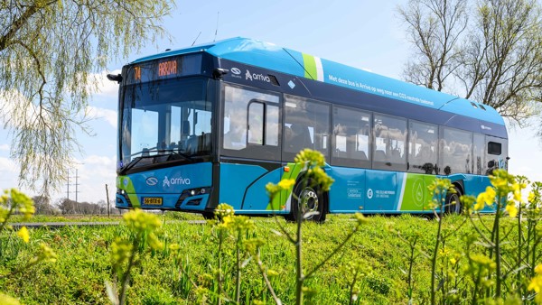 Een blauwe Arriva-waterstofbus rijdt over de weg in een groene omgeving. Een blauwe Arriva-waterstofbus rijdt over de weg in een groene omgeving.